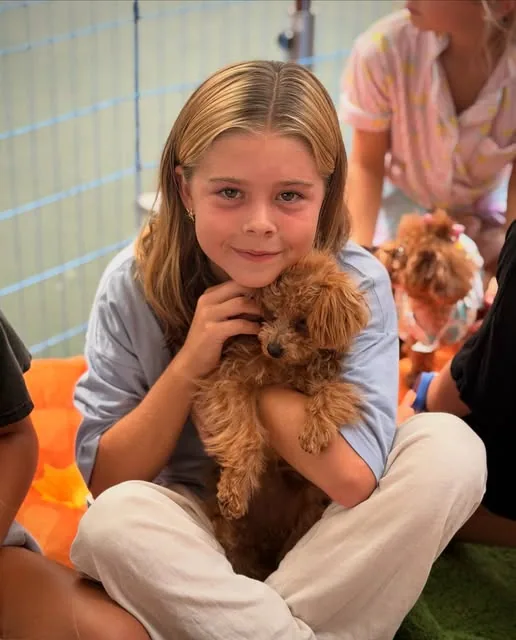 Girl holding a teacup poodle