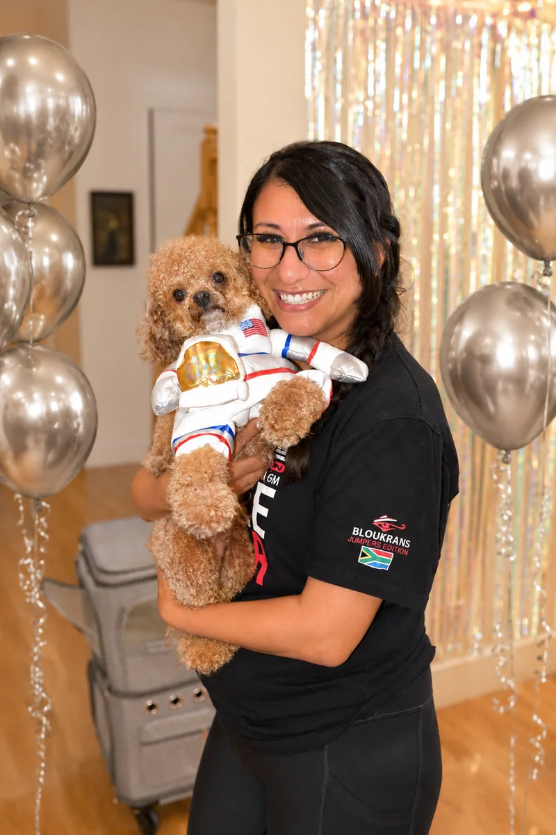 Star Poodlez host holding a poodle